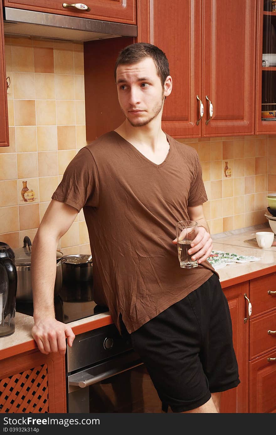 Guy In The Kitchen With Glass Of Water