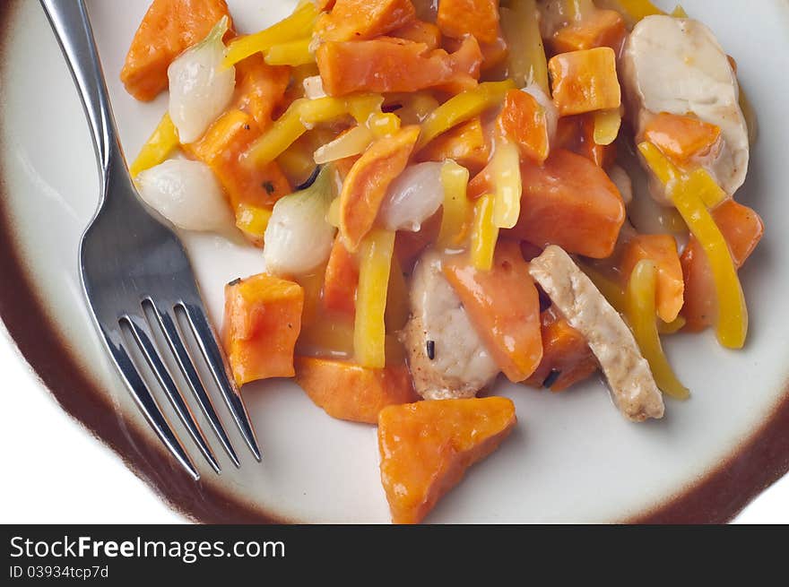 Chicken Sweet Potato and Pearl Onion Dinner with Sauce and Yellow Pepper Slivers.