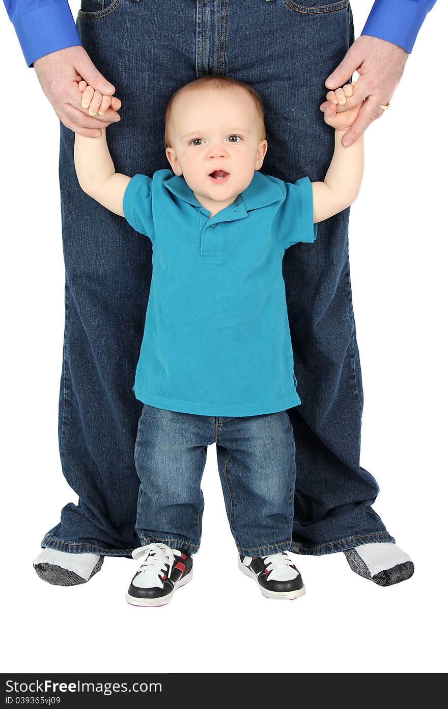 Father holding his one year old son's hands. Father holding his one year old son's hands