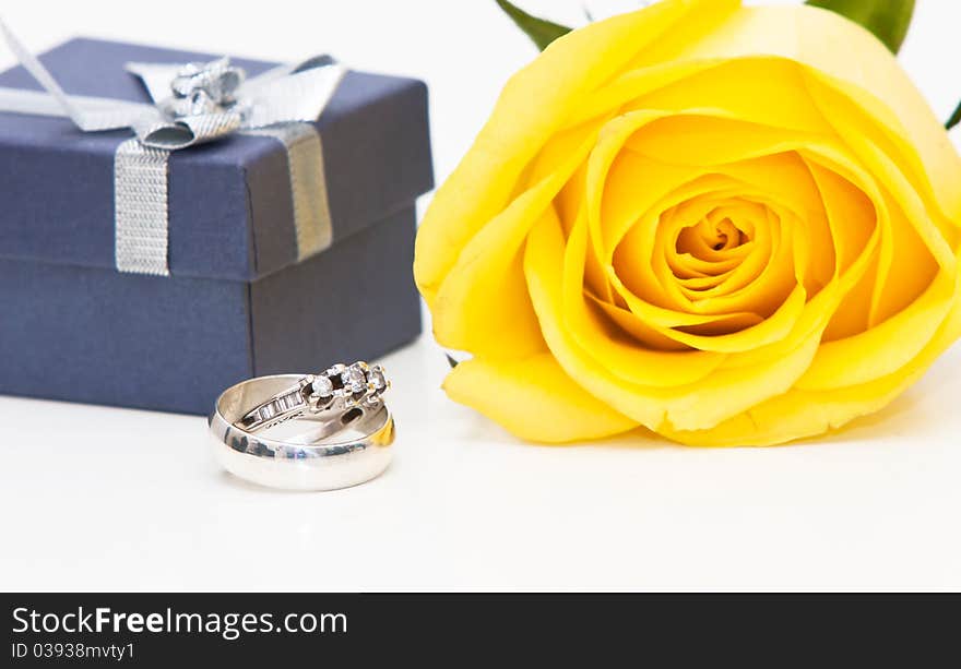 A diamond ring and yellow rose. A diamond ring and yellow rose.