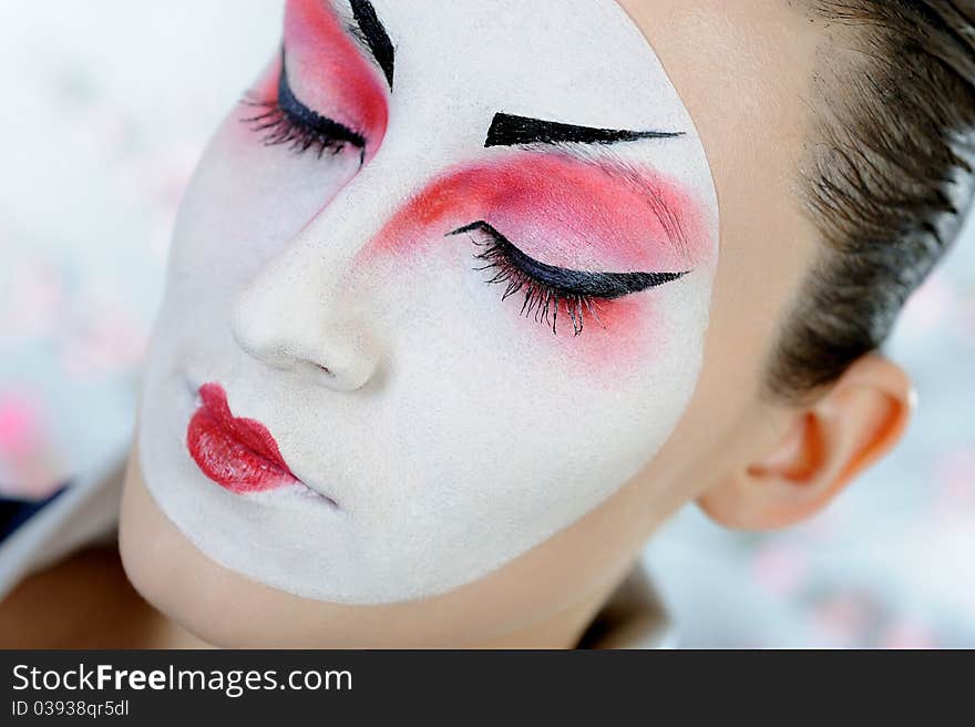 Close-up artistic portrait of japan geisha woman with creative make-up