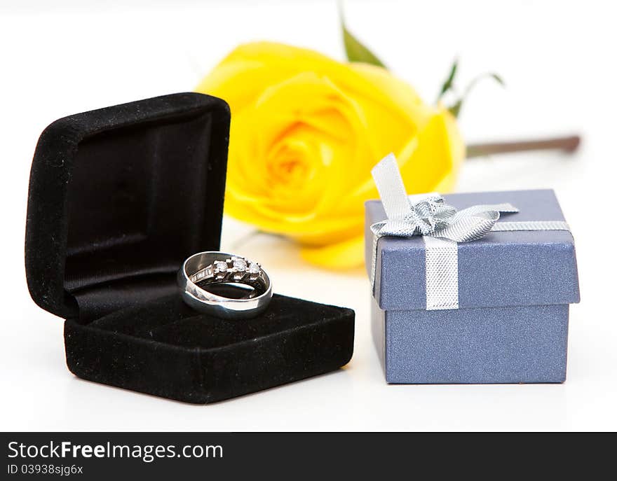 A diamond ring and yellow rose. A diamond ring and yellow rose