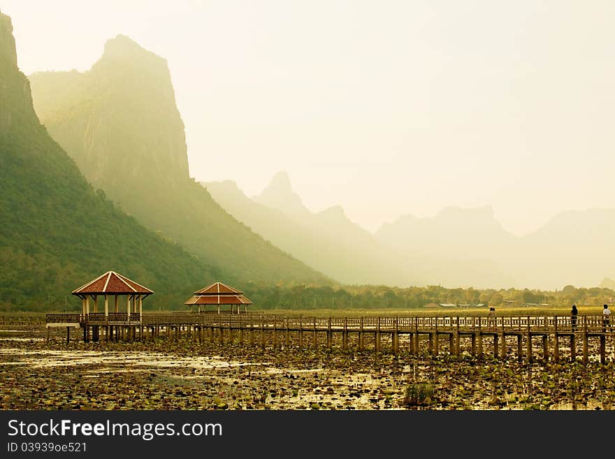 Footbridge in lake into the mountain, thailand