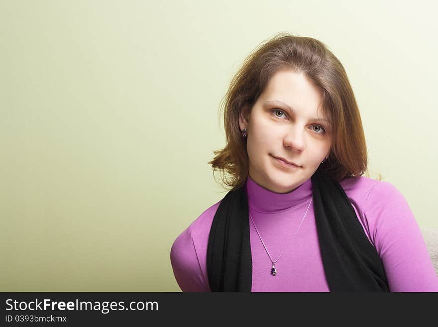 The young attractive woman in pink clothes on a green background. The young attractive woman in pink clothes on a green background