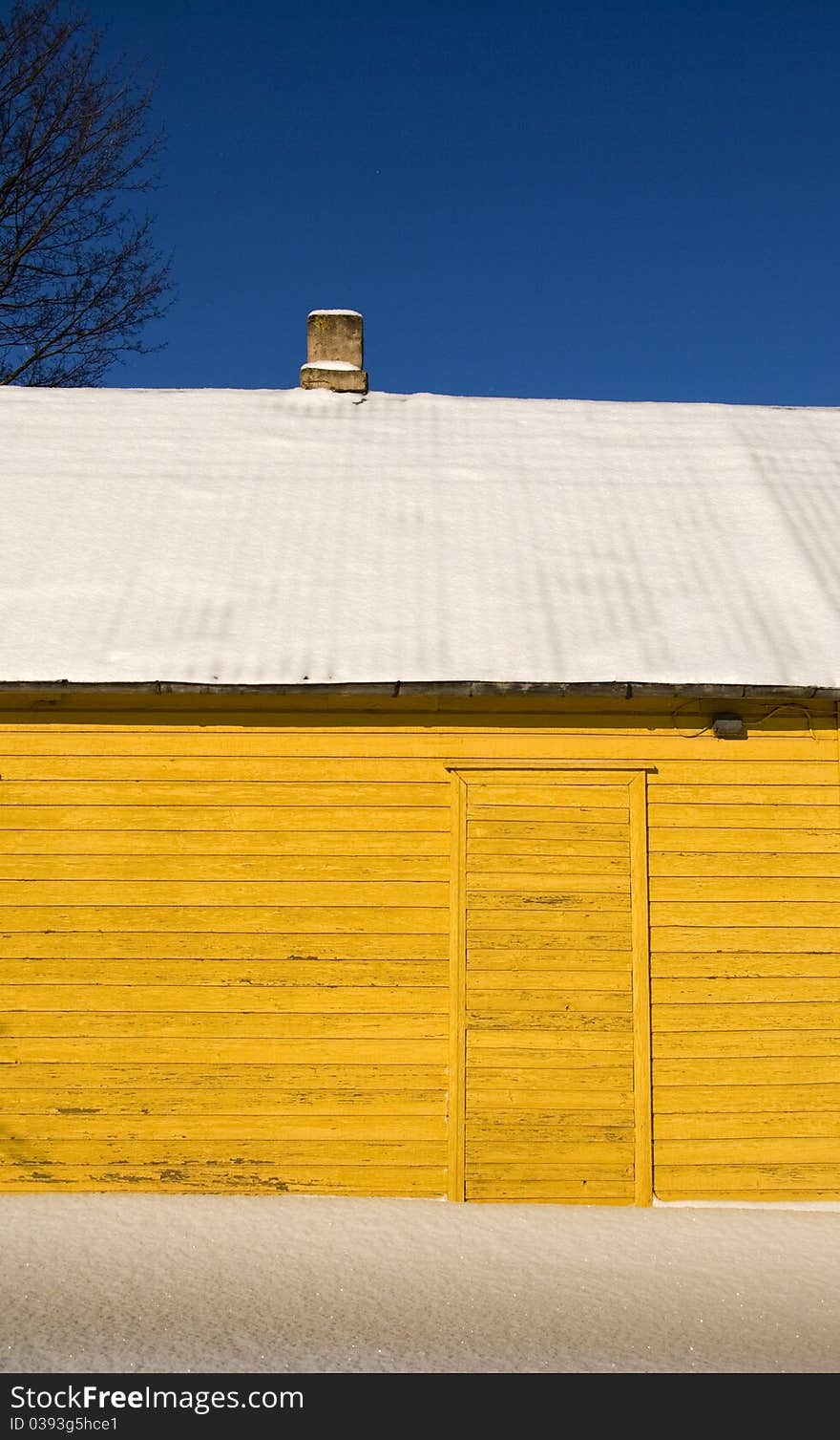 Yellow winter house fragment and snow