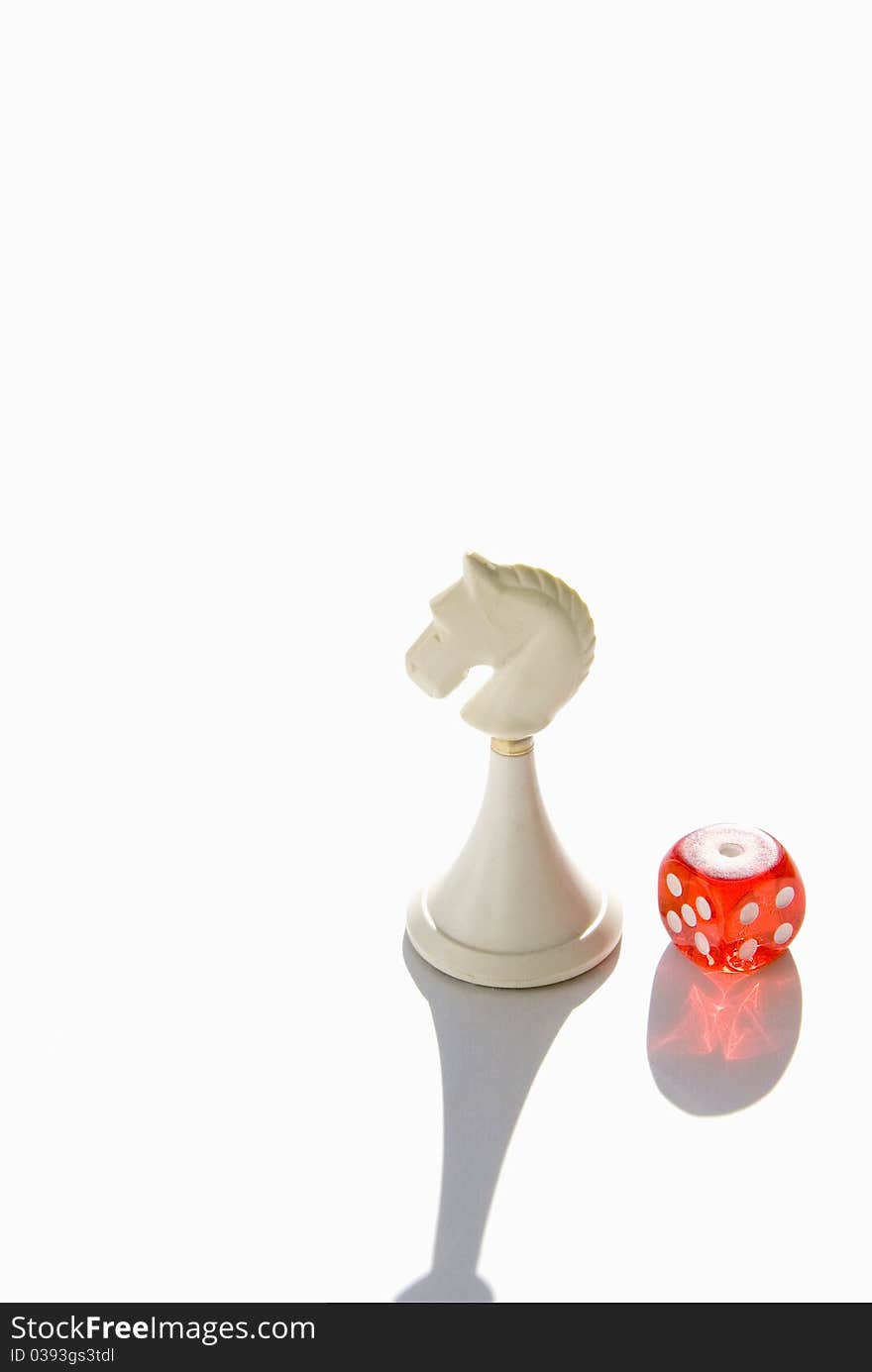 Red dice and white chess knight. Red dice and white chess knight