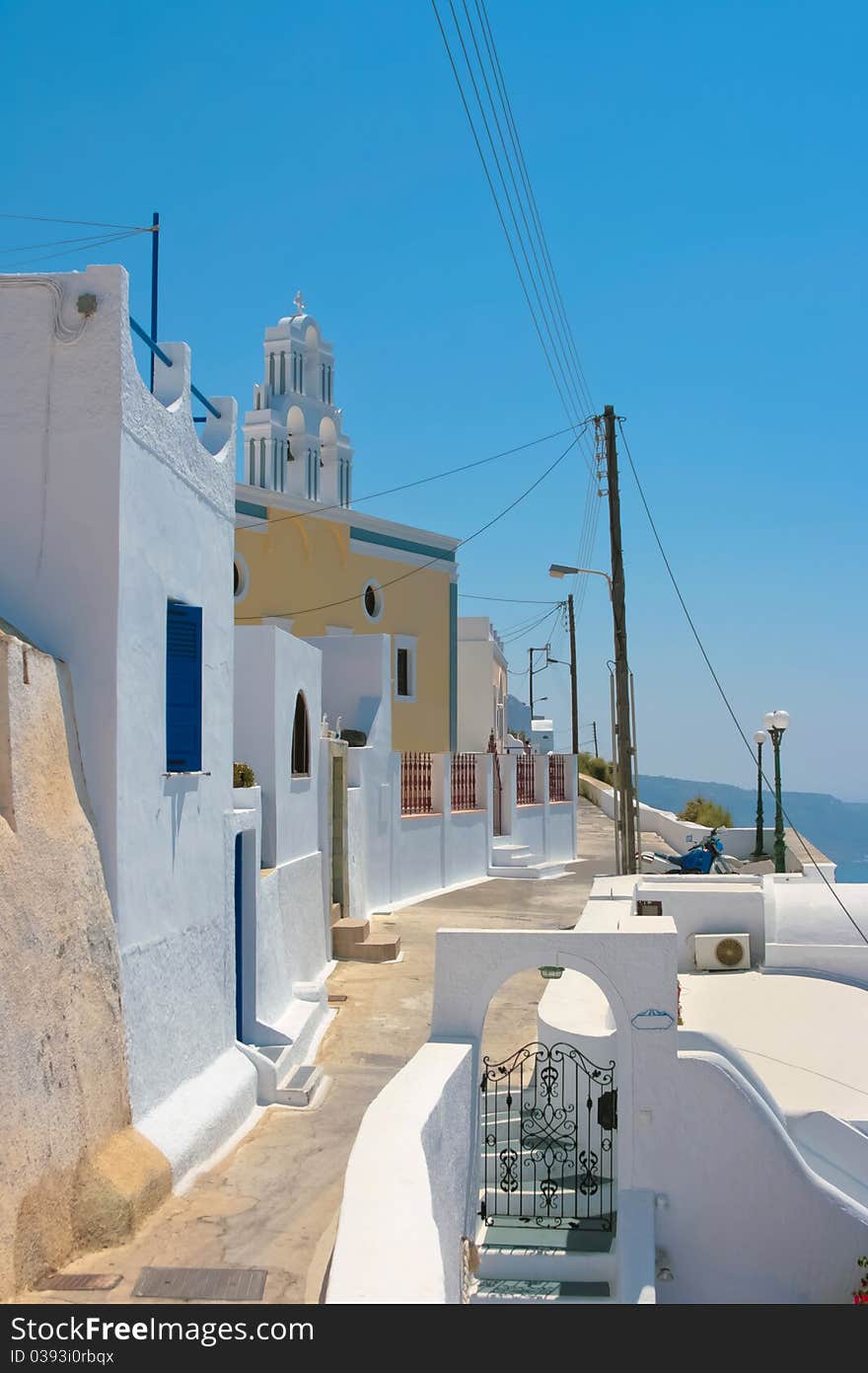 Beautiful empty street and traditional architecture on island of Santorini in Fira, Greece. Beautiful empty street and traditional architecture on island of Santorini in Fira, Greece.