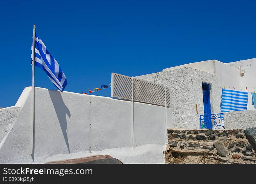 White Old Street In Santorini With Greece Flag