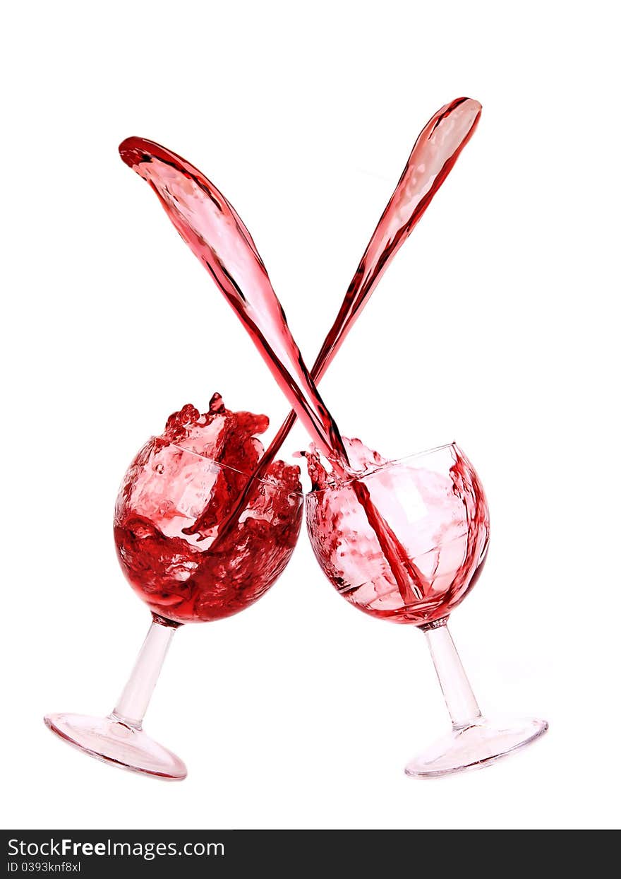 Studio photo of splashing red wine glasses.Isolated on white background. Studio photo of splashing red wine glasses.Isolated on white background