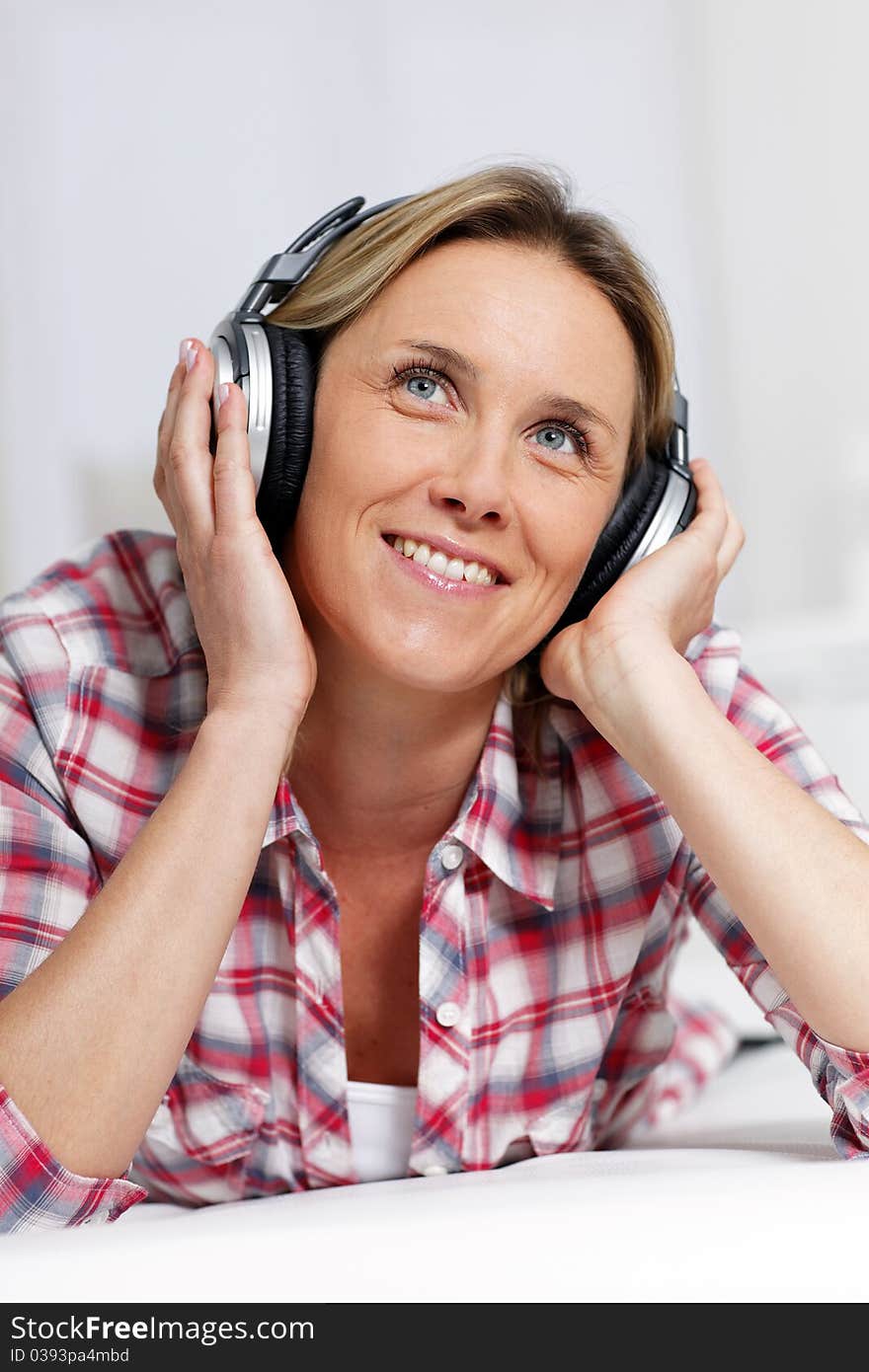 Woman listening music with headphones. Woman listening music with headphones