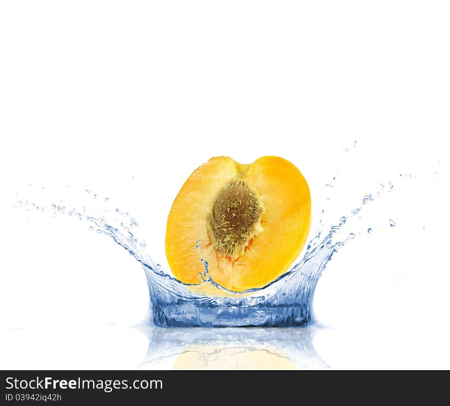 SLice of apricot falling into water, isolated on white background. SLice of apricot falling into water, isolated on white background