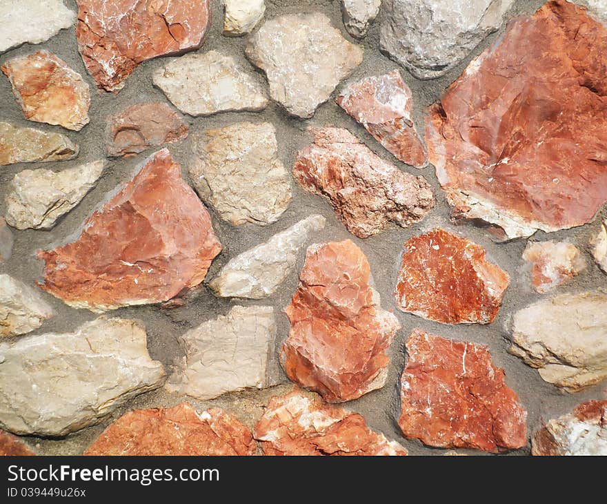 A stone wall made of red and white of the Crimean stone