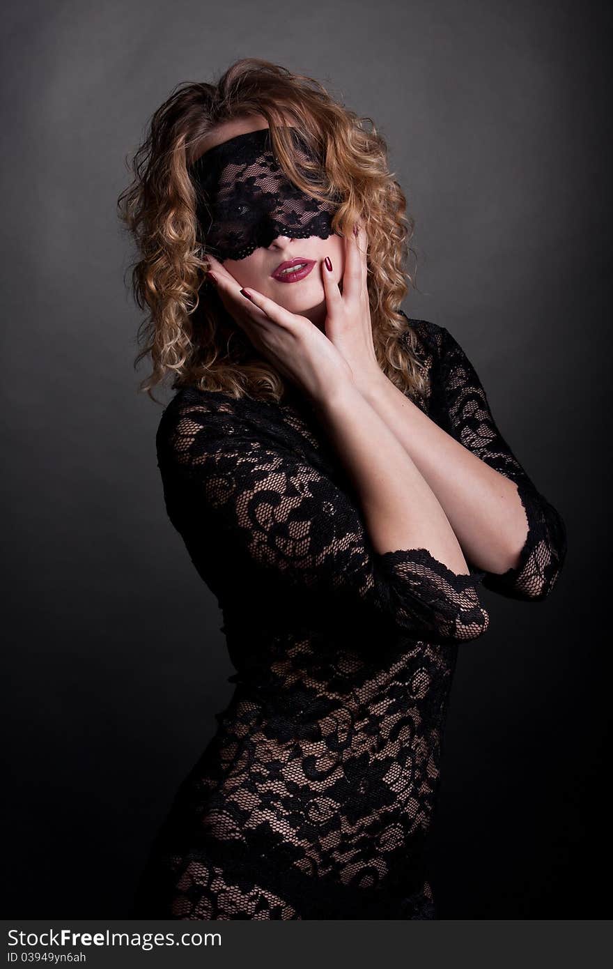 Beautiful woman with red lips and lace mask over her eyes. Beautiful woman with red lips and lace mask over her eyes.