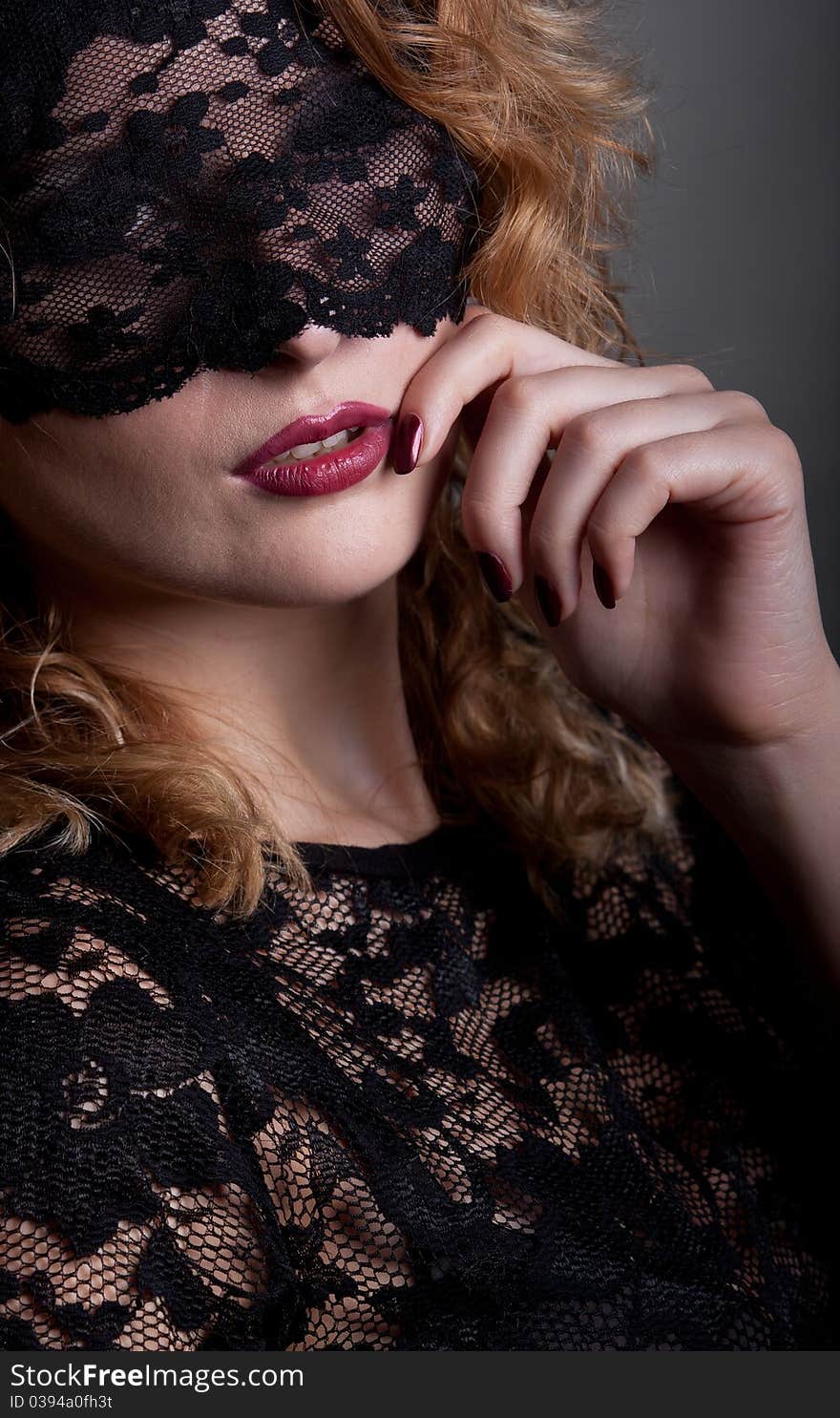 Beautiful woman with red lips and lace mask over her eyes. Beautiful woman with red lips and lace mask over her eyes.