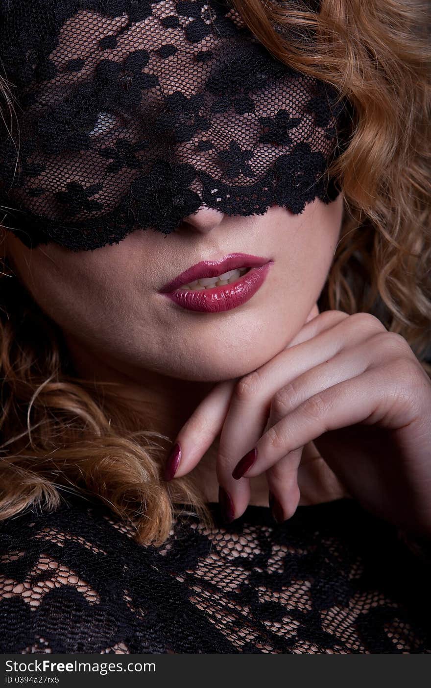 Beautiful woman with red lips and lace mask over her eyes. Beautiful woman with red lips and lace mask over her eyes.