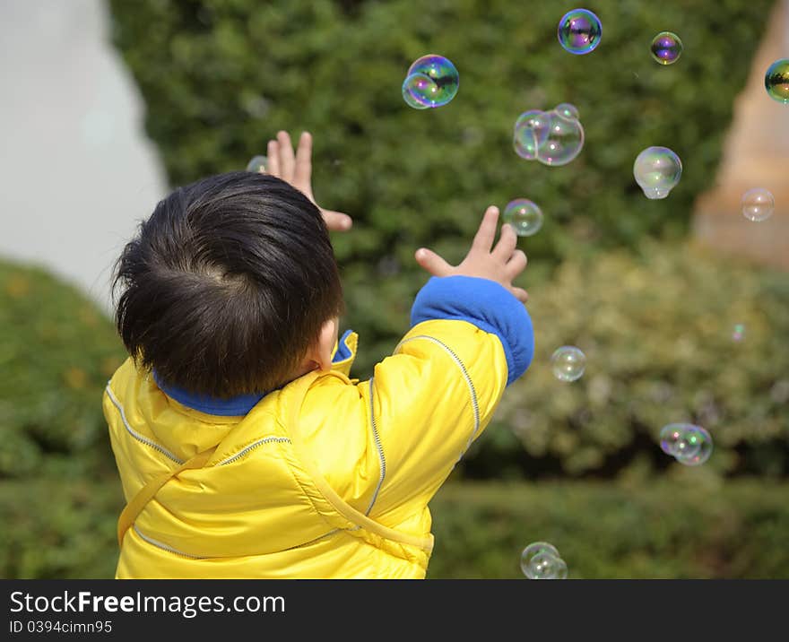 A baby playing soap bubbles. A baby playing soap bubbles