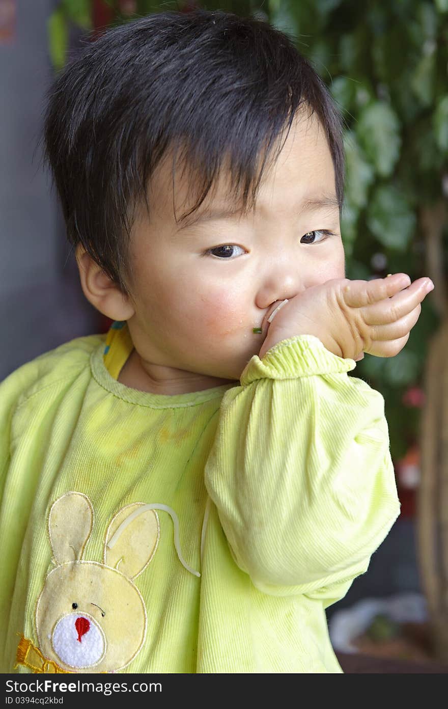 A cute baby is eating in restaurant