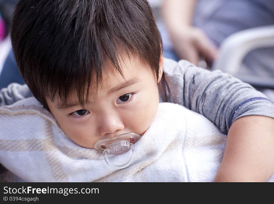 A cute baby is sleeping and look at photographer. A cute baby is sleeping and look at photographer