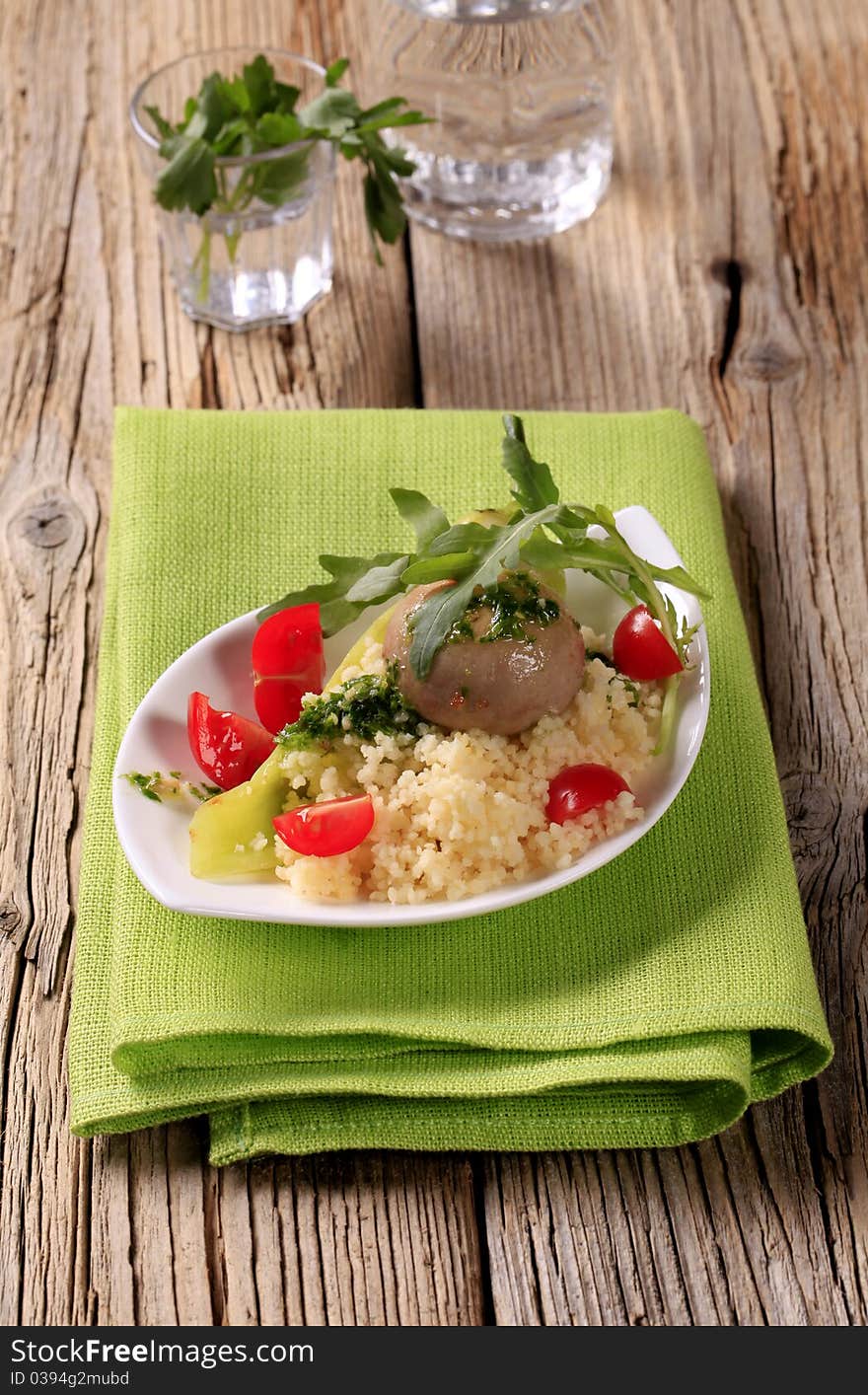 Couscous, button mushroom with pesto and fresh vegetables. Couscous, button mushroom with pesto and fresh vegetables