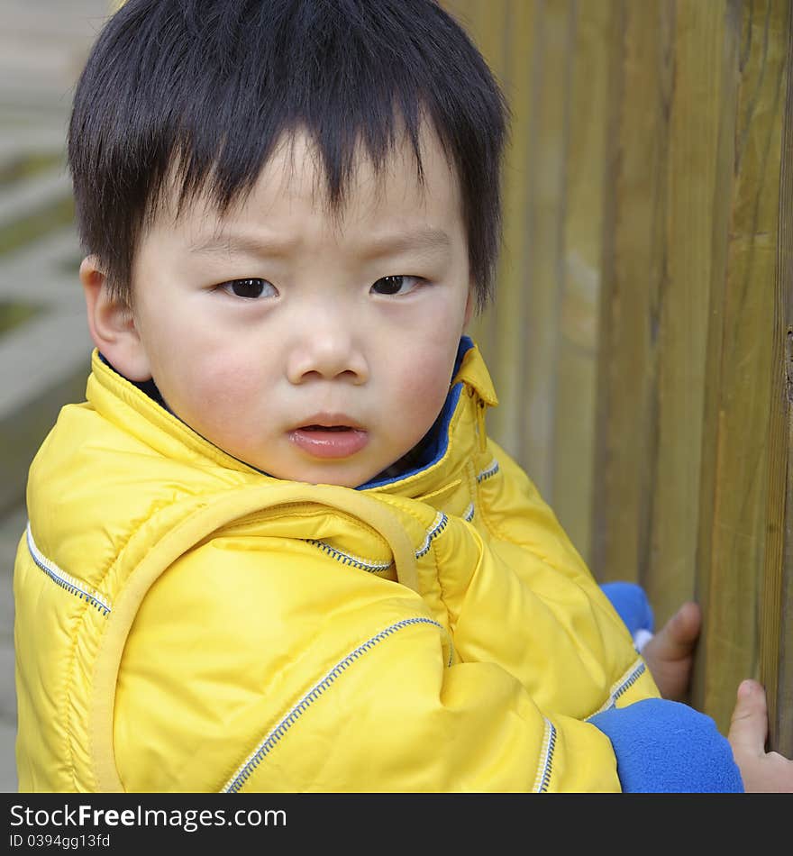 A cute baby is playing in a park. A cute baby is playing in a park