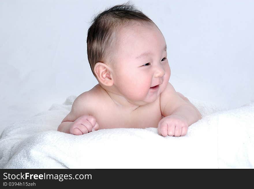 Baby Laying On The White Bed