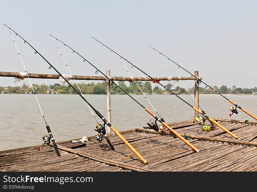 Fishing Poles on Pier with river in Background