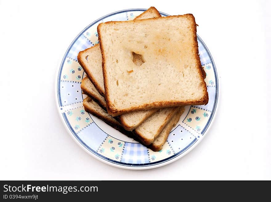 Bread toast on plate isolated against a plain background