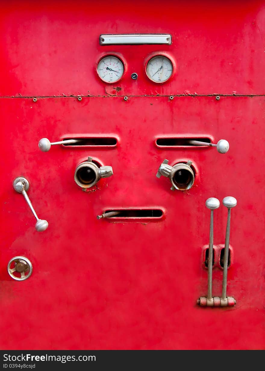 The Chrome dials and valves on old red fire truck