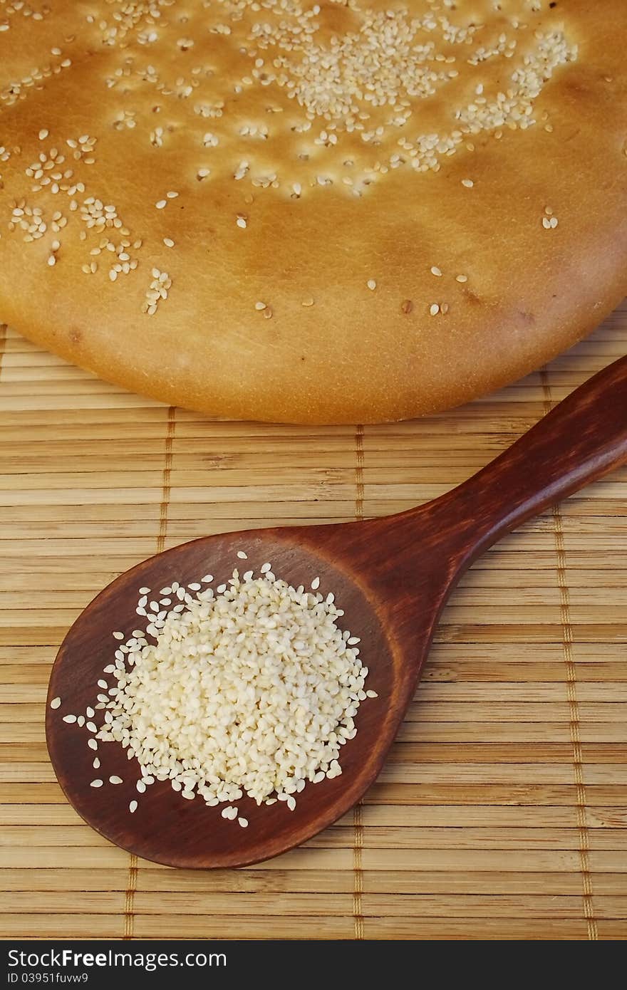 Rustic roll bread with sesame on a table