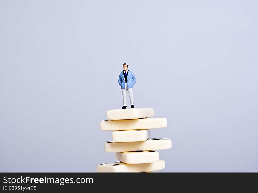 One man standing on pile of domino cubes