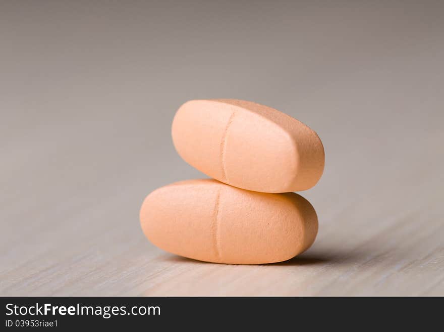 Pills on a wooden table