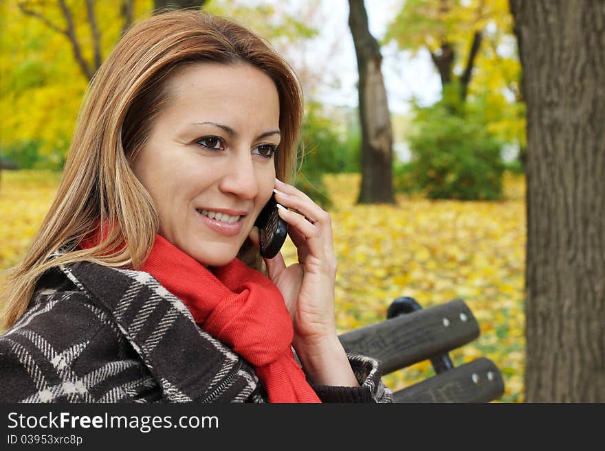 Woman in Park talking on a mobile phone