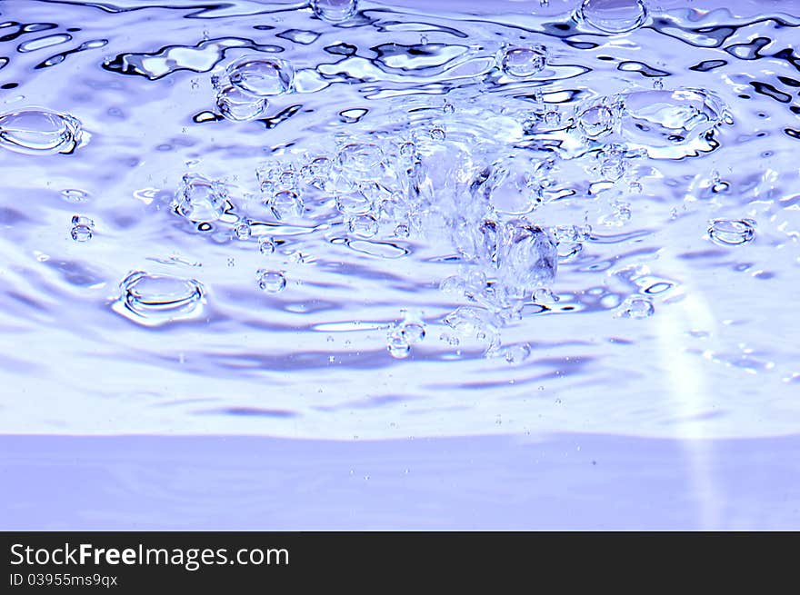 Blue water with air bubbles in the water line. Blue water with air bubbles in the water line.