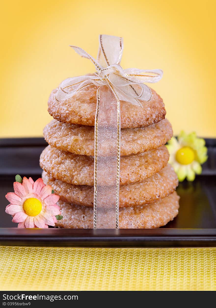 Ginger cookies tied with ribbon on black plate. Ginger cookies tied with ribbon on black plate