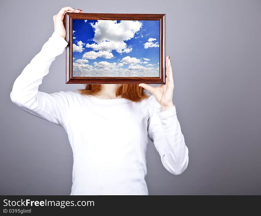 Girl keep frame with clouds sky inside.