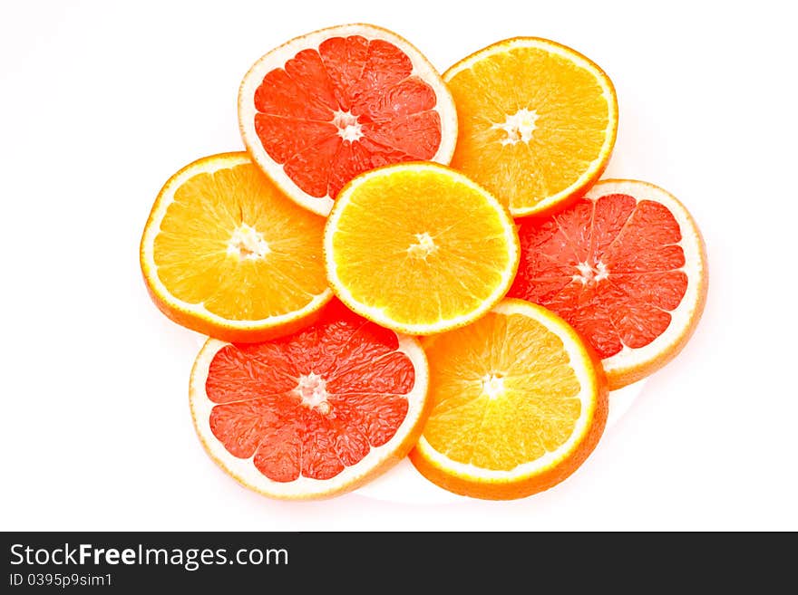 Grapefruit and orange slices cut into isolated on a white background