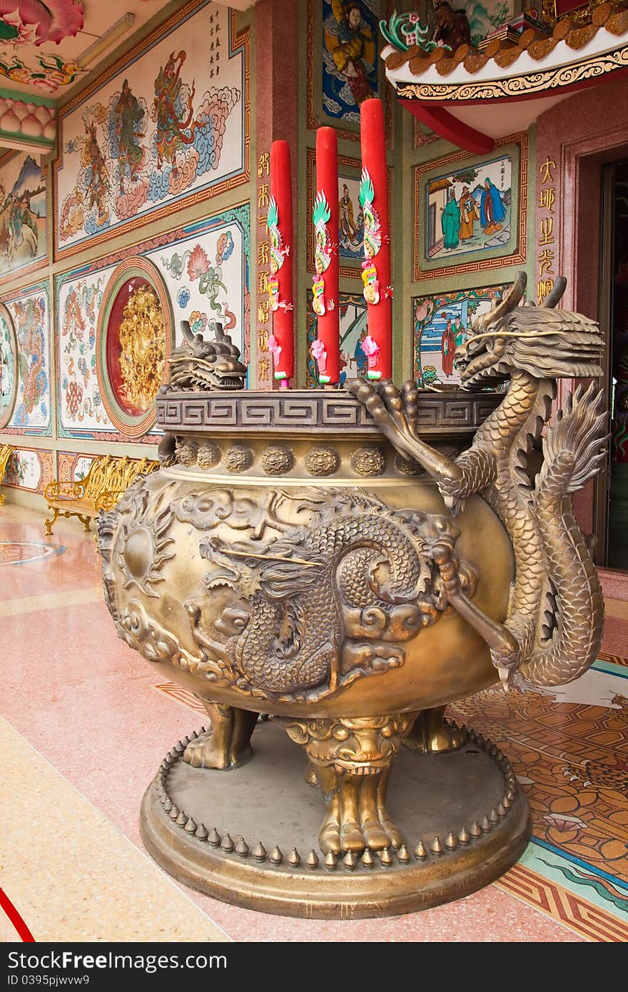 Chinese dragon incense burner in front of Chinese temple.