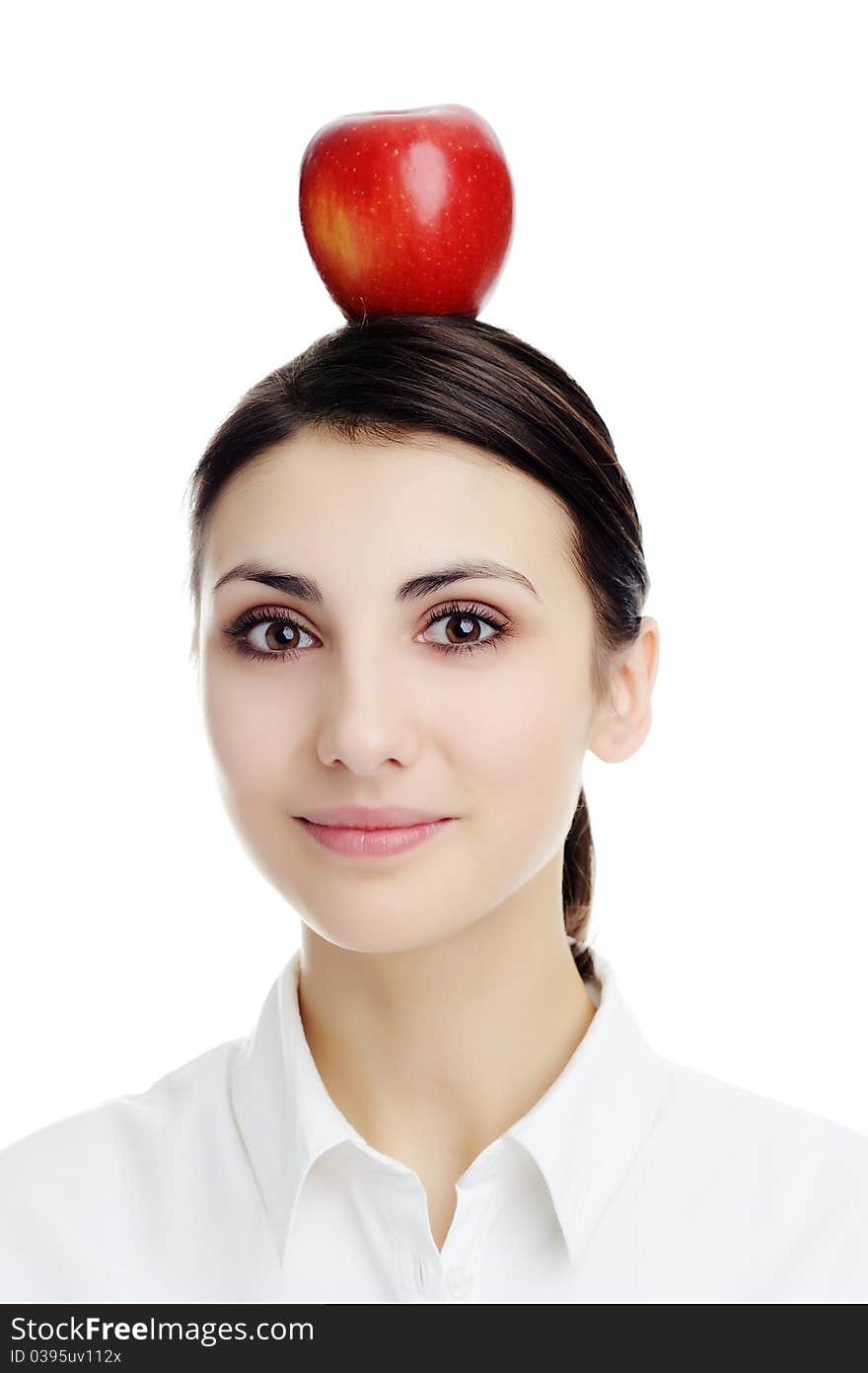 An image of girl with apple on her head. An image of girl with apple on her head.