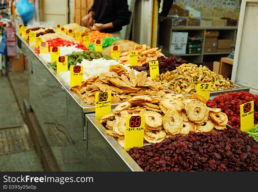 Close up of many colorful dried fruits on market stand