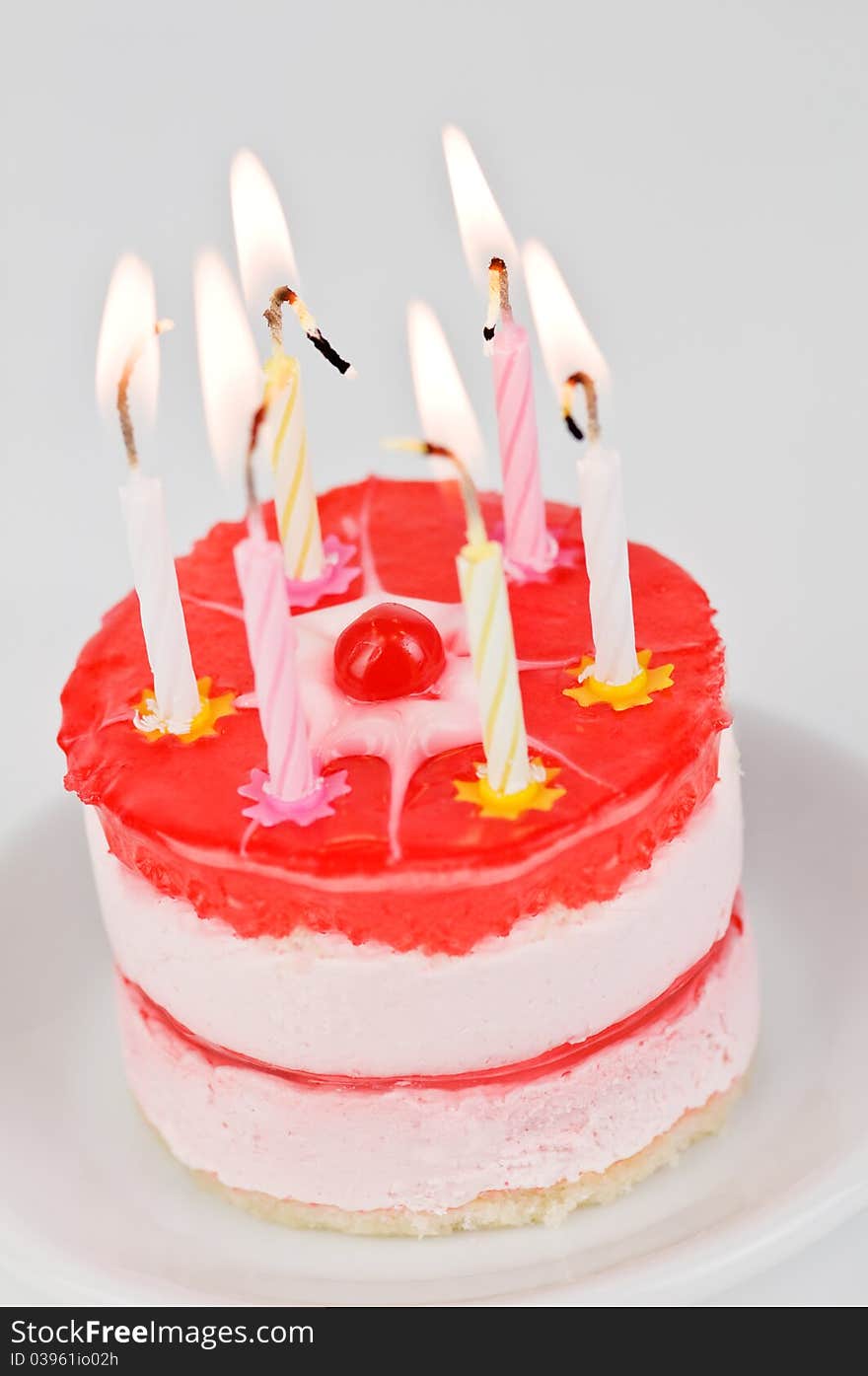 Cake with candle on wood table