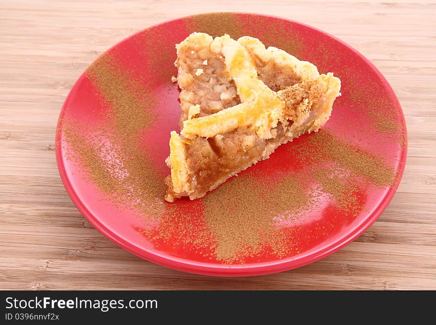 Apple Pie - a slice on a plate decorated with cinnamon