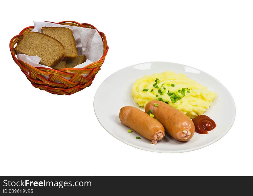 Two sausages with mashed potatoes on a plate and bread in a basket isolated on a white background