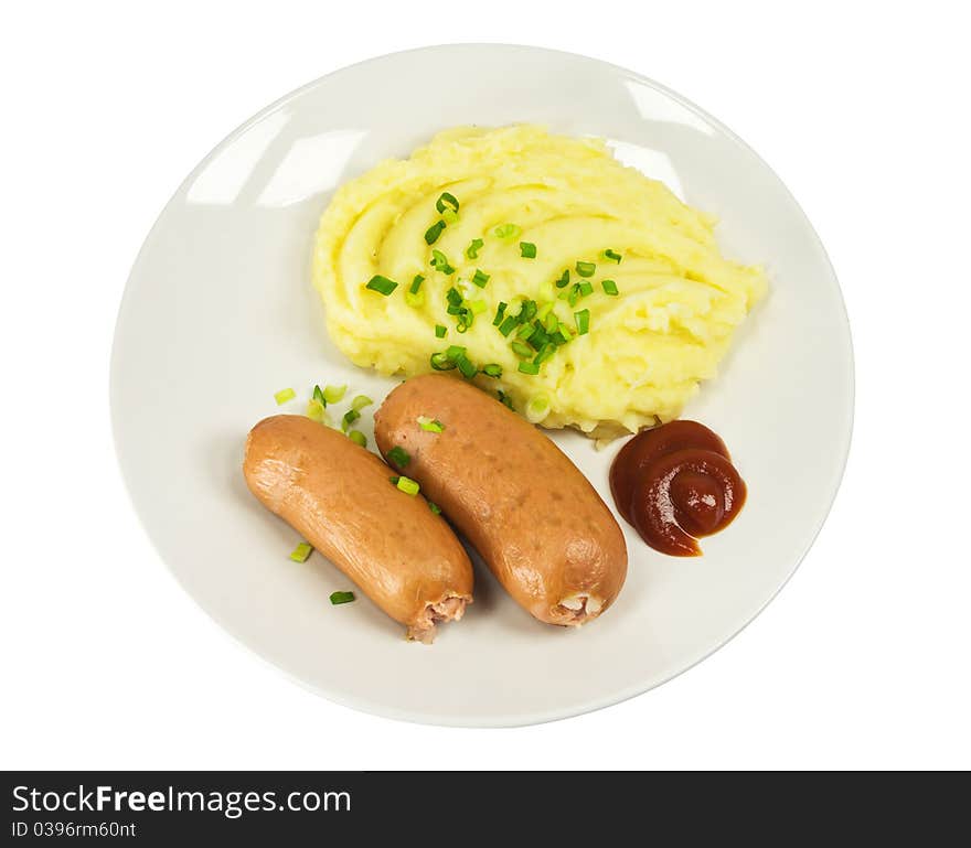 Two sausages with mashed potatoes on a plate isolated on white background