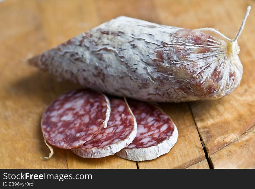 Salami pieces on wood table