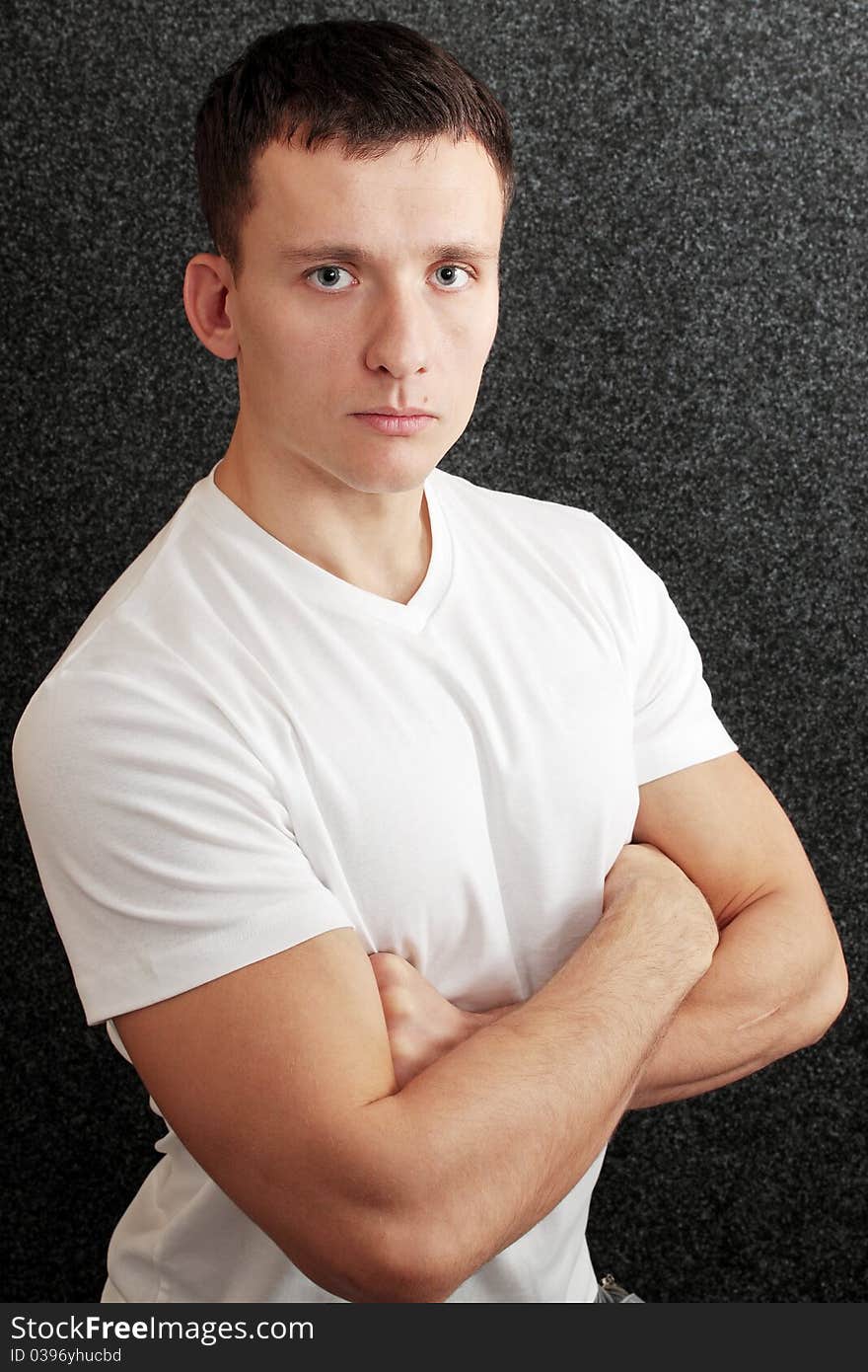 Portrait of young man against the dark background