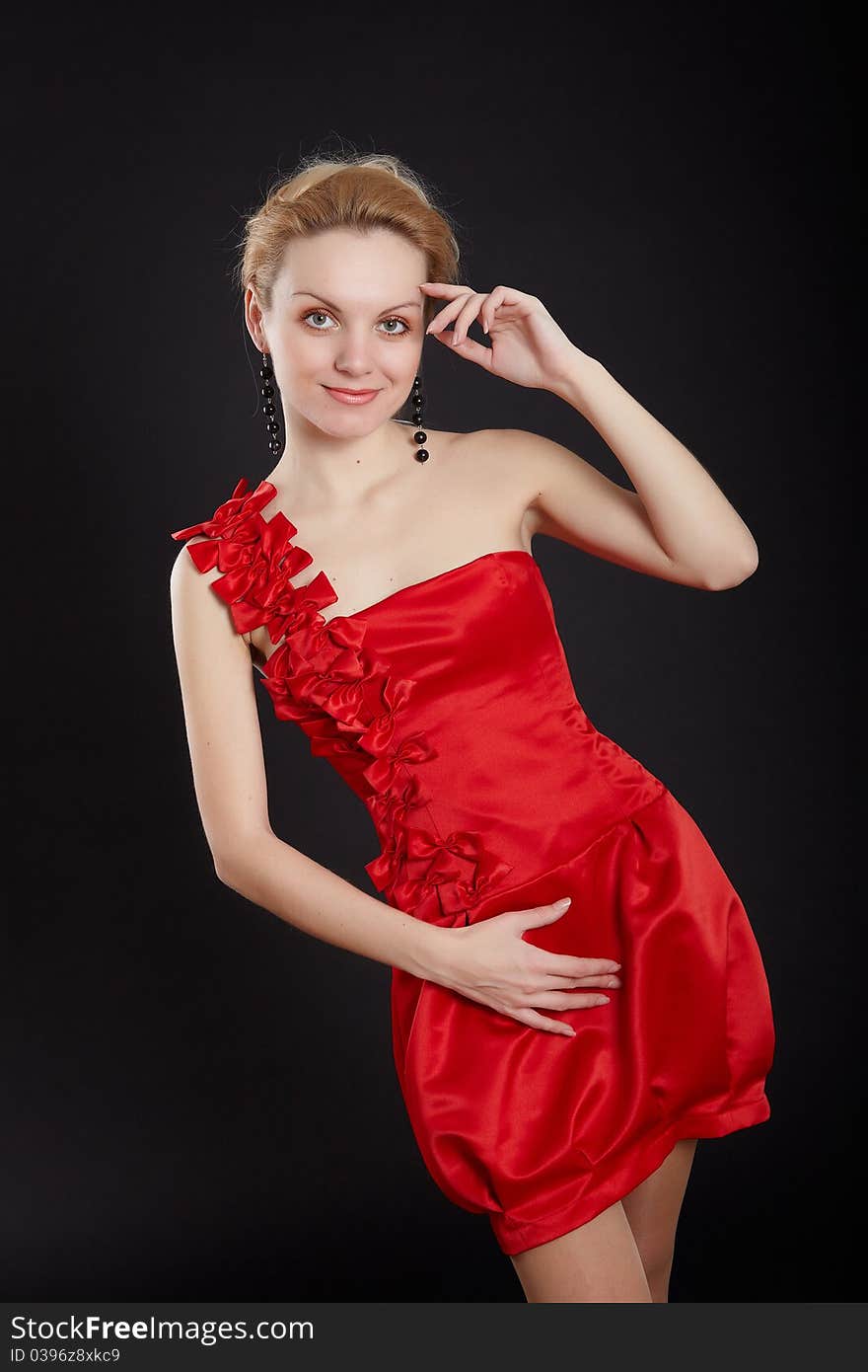 Fashion girl in red dress on black background. Fashion girl in red dress on black background