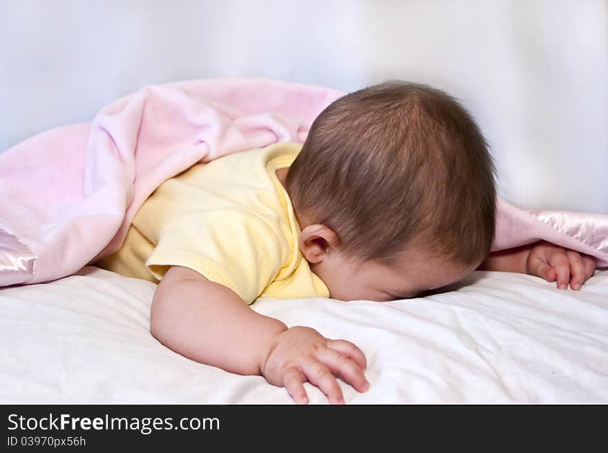 Little girl throws her head in the pillow during the shoot hoping it will be over real soon !!!. Little girl throws her head in the pillow during the shoot hoping it will be over real soon !!!