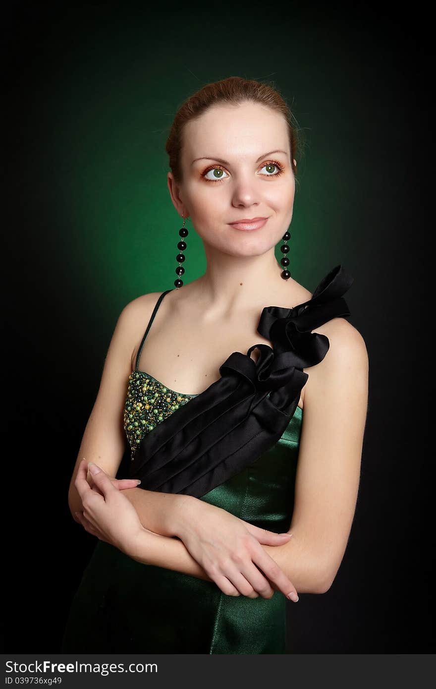 Fashion girl in green dress on black background. Fashion girl in green dress on black background