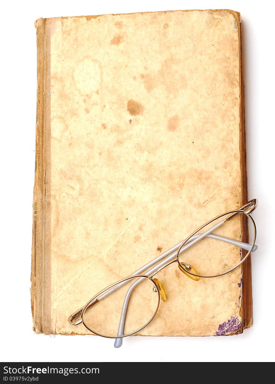 Old book with eyeglass on white background