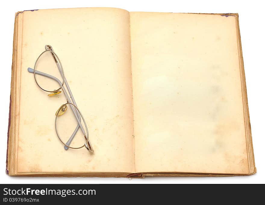 Opened old book with eyeglass isolated on white background